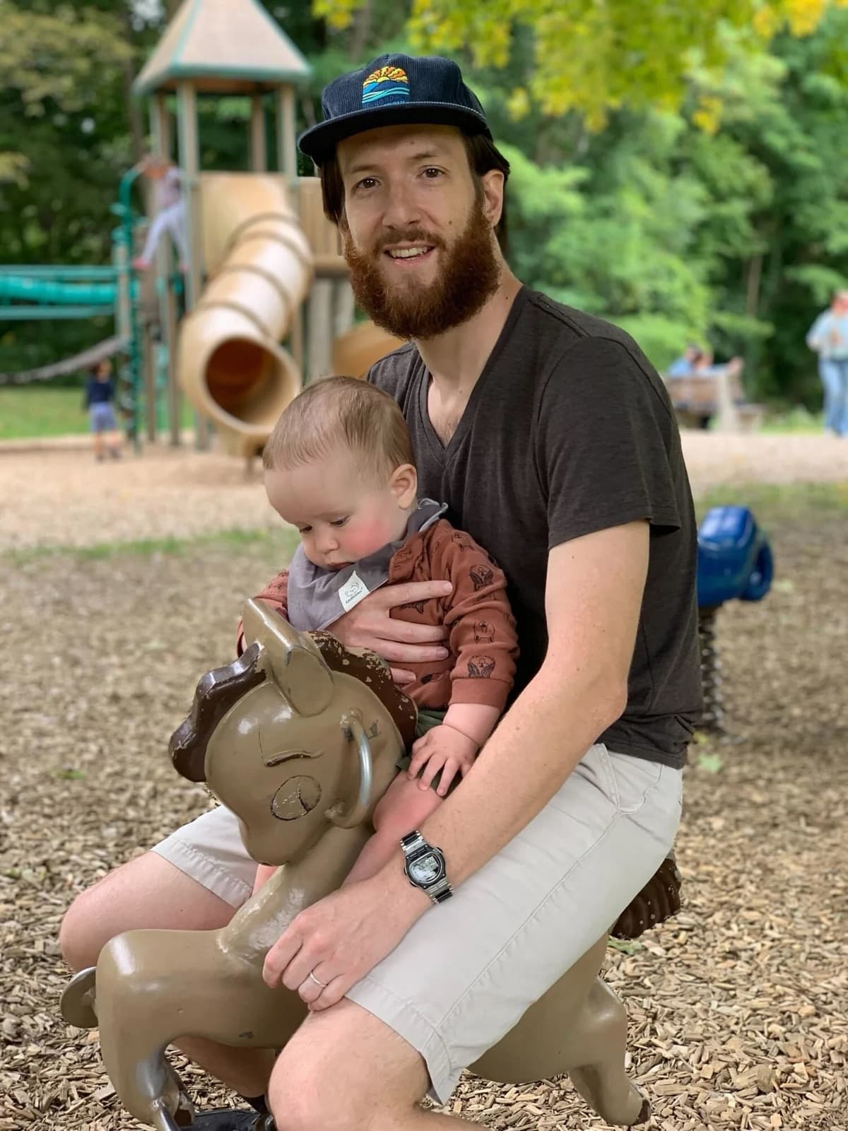 Justin with his son Max at a playground