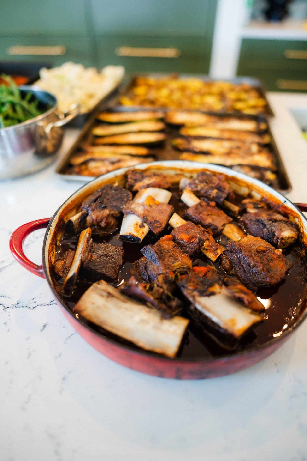 Braised short ribs cooking in a dutch oven